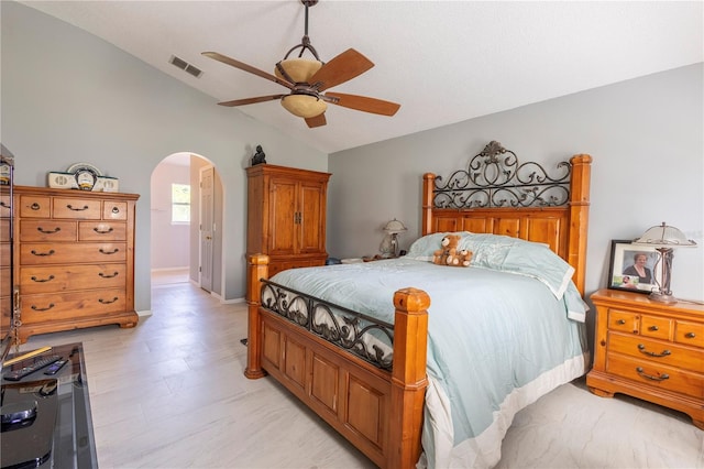 3216 White Blossom Ln, Clermont, FL 34711 - bedroom featuring vaulted ceiling, arched walkways, ceiling fan, and light floors