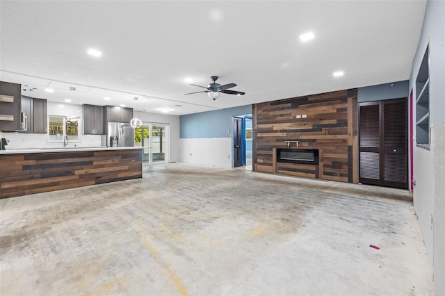 2302 16th St W, Palmetto, FL 34221 - unfurnished living room featuring concrete flooring, ceiling fan, and recessed lighting