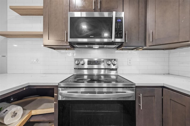 2302 16th St W, Palmetto, FL 34221 - kitchen featuring appliances with stainless steel finishes, dark brown cabinets, tasteful backsplash, and light countertops