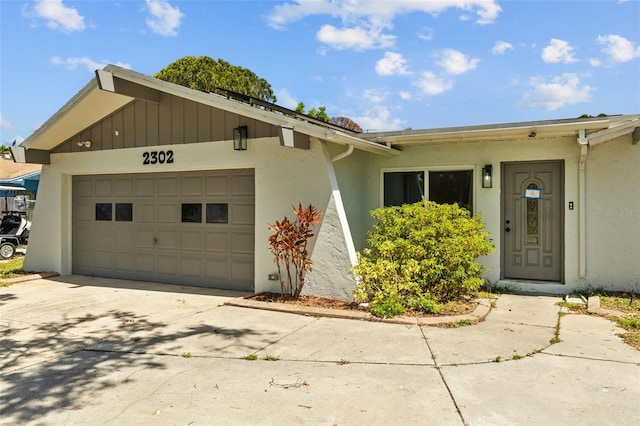 2302 16th St W, Palmetto, FL 34221 - view of front of house featuring an attached garage, driveway, and stucco siding