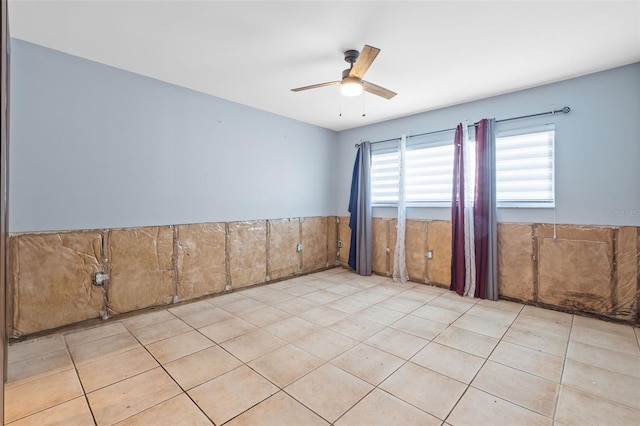 2302 16th St W, Palmetto, FL 34221 - spare room with ceiling fan, wainscoting, and tile patterned flooring