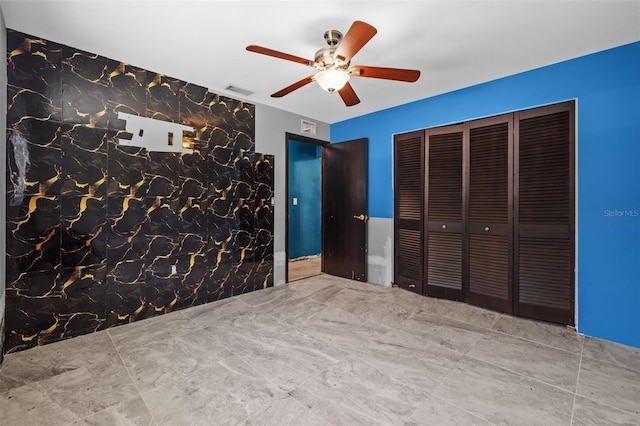 2302 16th St W, Palmetto, FL 34221 - unfurnished bedroom with ceiling fan and a closet