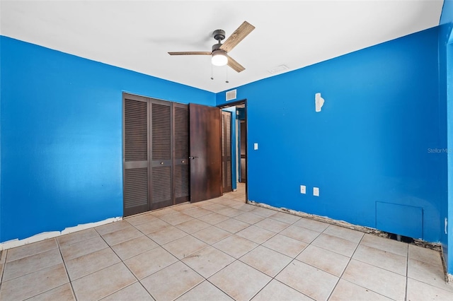 2302 16th St W, Palmetto, FL 34221 - unfurnished bedroom with a closet, ceiling fan, and tile patterned flooring