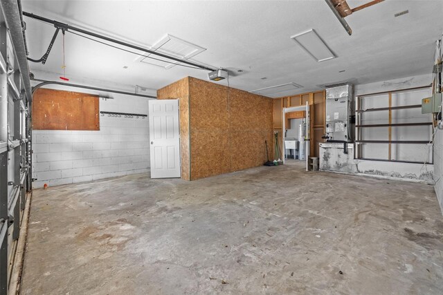 2302 16th St W, Palmetto, FL 34221 - garage with a garage door opener, heating unit, and concrete block wall