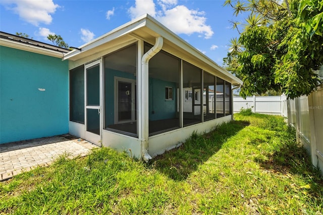 2302 16th St W, Palmetto, FL 34221 - view of side of home with a sunroom and a fenced backyard