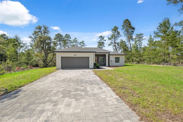 3072 SW 168th Loop, Ocala, FL 34473 - view of front of house featuring decorative driveway, stucco siding, an attached garage, and a front lawn