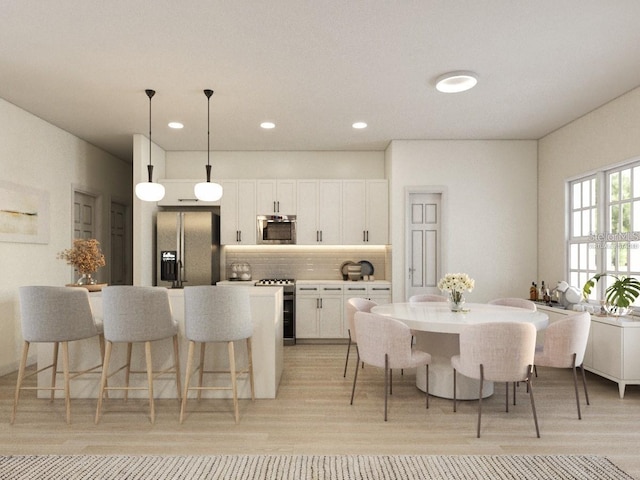 3072 SW 168th Loop, Ocala, FL 34473 - kitchen featuring refrigerator with ice dispenser, stainless steel range oven, decorative backsplash, white cabinetry, and a kitchen breakfast bar