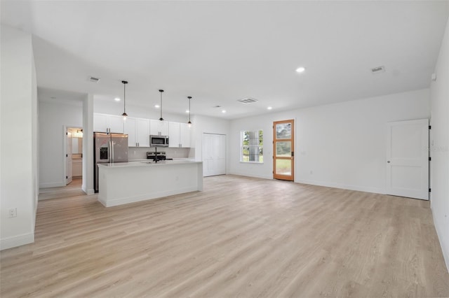3072 SW 168th Loop, Ocala, FL 34473 - unfurnished living room featuring light wood-style flooring, recessed lighting, and baseboards