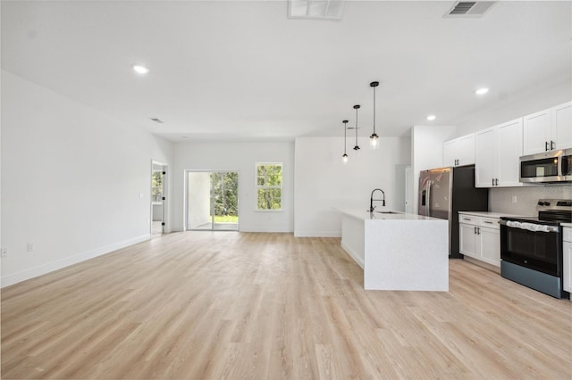 3072 SW 168th Loop, Ocala, FL 34473 - kitchen with appliances with stainless steel finishes, a sink, open floor plan, light wood-type flooring, and recessed lighting