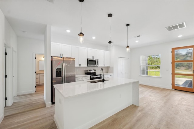 3072 SW 168th Loop, Ocala, FL 34473 - kitchen with appliances with stainless steel finishes, a sink, white cabinetry, light wood-type flooring, and recessed lighting