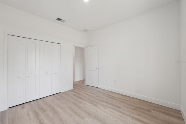 3072 SW 168th Loop, Ocala, FL 34473 - unfurnished bedroom with light wood-style flooring, baseboards, and a closet