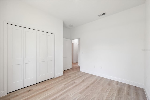 3072 SW 168th Loop, Ocala, FL 34473 - unfurnished bedroom featuring light wood-style flooring, baseboards, and a closet