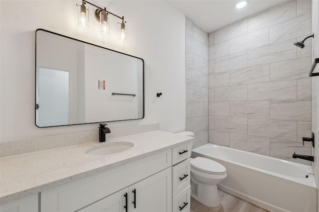 3072 SW 168th Loop, Ocala, FL 34473 - bathroom with toilet, vanity, bathtub / shower combination, wood finished floors, and recessed lighting