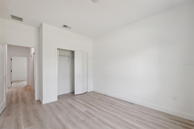 3072 SW 168th Loop, Ocala, FL 34473 - unfurnished bedroom featuring light wood-style flooring, a closet, and baseboards