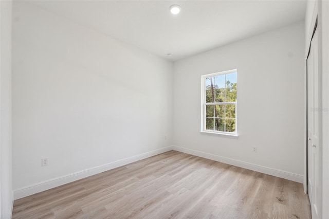 3072 SW 168th Loop, Ocala, FL 34473 - unfurnished bedroom featuring light wood-style floors, baseboards, a closet, and recessed lighting