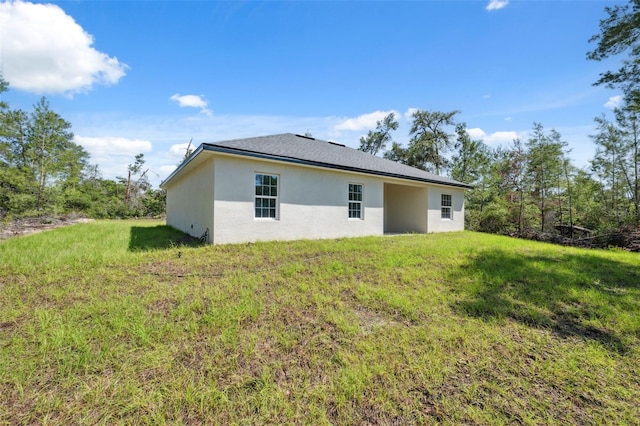 3072 SW 168th Loop, Ocala, FL 34473 - rear view of property featuring stucco siding and a yard