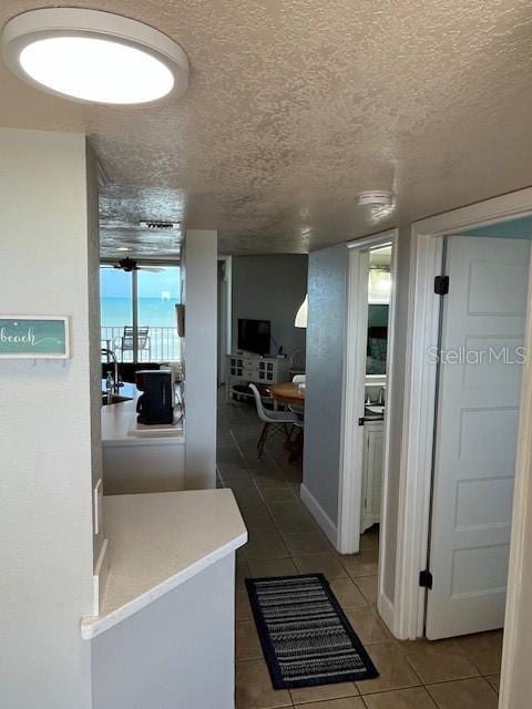4453 S Atlantic Ave Unit 602, Ponce Inlet, FL 32127 - hallway with tile patterned flooring and a textured ceiling