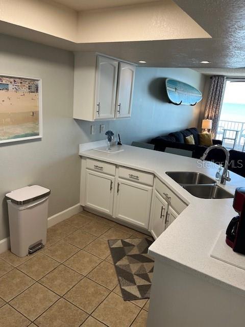 4453 S Atlantic Ave Unit 602, Ponce Inlet, FL 32127 - kitchen with a sink, light tile patterned floors, and light countertops
