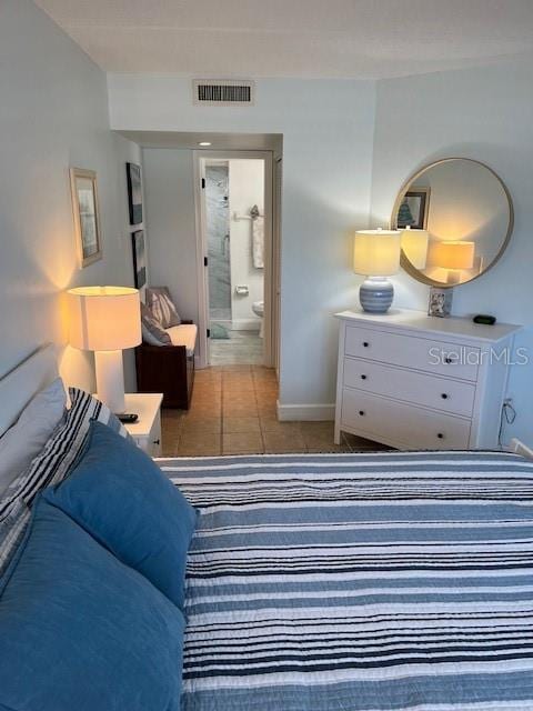 4453 S Atlantic Ave Unit 602, Ponce Inlet, FL 32127 - bedroom featuring baseboards, tile patterned floors, and ensuite bathroom