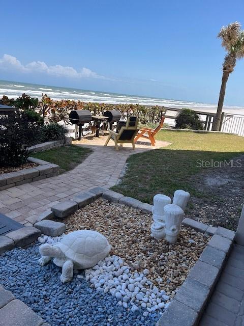 4453 S Atlantic Ave Unit 602, Ponce Inlet, FL 32127 - view of green lawn with view of water and beach