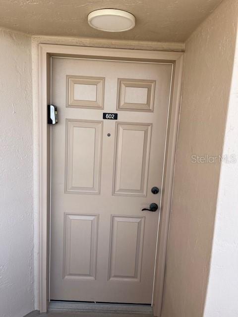4453 S Atlantic Ave Unit 602, Ponce Inlet, FL 32127 - view of exterior entry with stucco siding