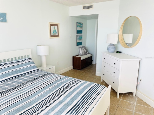 4453 S Atlantic Ave Unit 602, Ponce Inlet, FL 32127 - bedroom featuring light tile patterned floors and baseboards