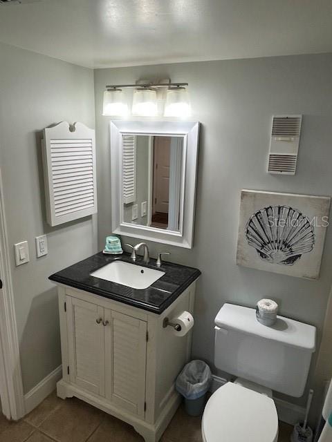 4453 S Atlantic Ave Unit 602, Ponce Inlet, FL 32127 - bathroom featuring vanity, toilet, tile patterned floors, and baseboards