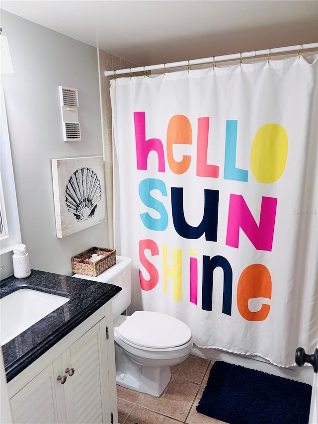 4453 S Atlantic Ave Unit 602, Ponce Inlet, FL 32127 - bathroom featuring toilet, vanity, tile patterned flooring, and curtained shower