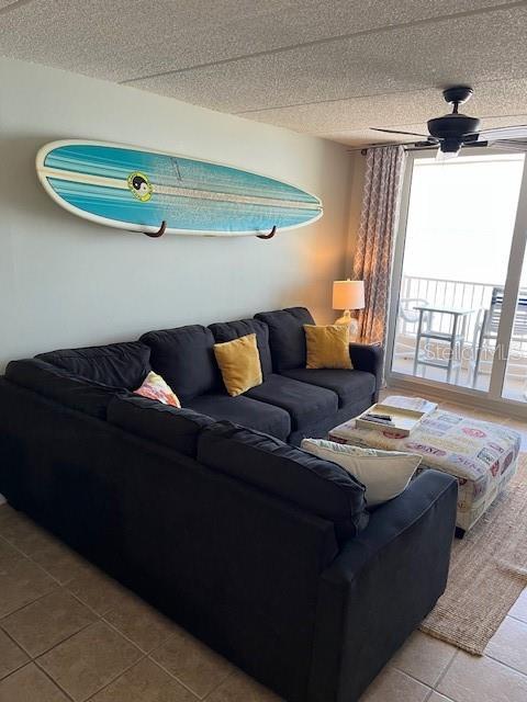 4453 S Atlantic Ave Unit 602, Ponce Inlet, FL 32127 - tiled living area featuring ceiling fan and a textured ceiling