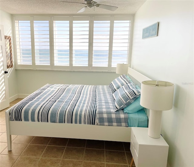 4453 S Atlantic Ave Unit 602, Ponce Inlet, FL 32127 - tiled bedroom with a textured ceiling and multiple windows