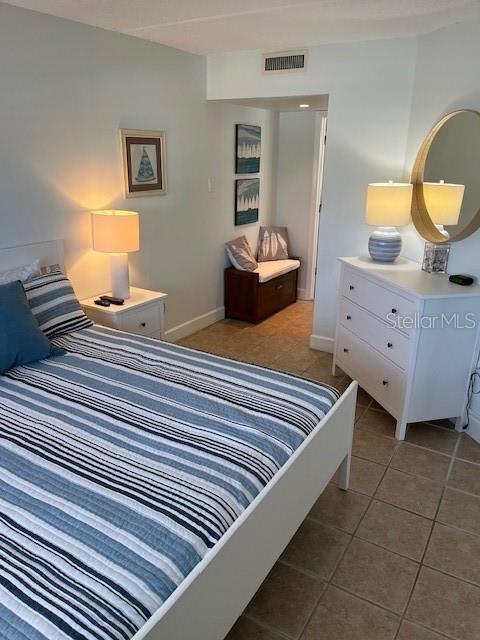 4453 S Atlantic Ave Unit 602, Ponce Inlet, FL 32127 - tiled bedroom with baseboards