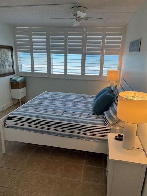 4453 S Atlantic Ave Unit 602, Ponce Inlet, FL 32127 - bedroom featuring tile patterned floors, a ceiling fan, and baseboards