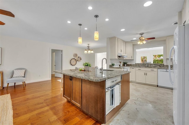 kitchen with ceiling fan, white appliances, a sink, under cabinet range hood, and recessed lighting
