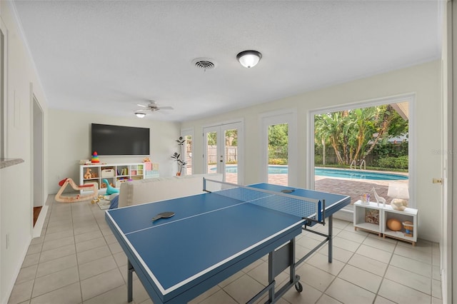 game room featuring french doors, light tile patterned floors, and a ceiling fan