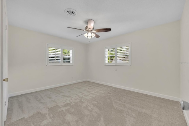 empty room featuring ceiling fan, carpet floors, and baseboards