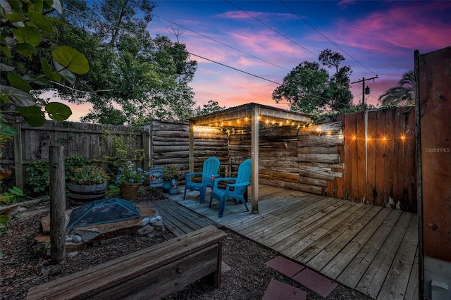 deck at dusk with a fenced backyard