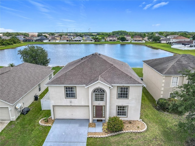 2384 Andrews Valley Dr, Kissimmee, FL 34758 - traditional home featuring a shingled roof, stucco siding, a water view, and a residential view