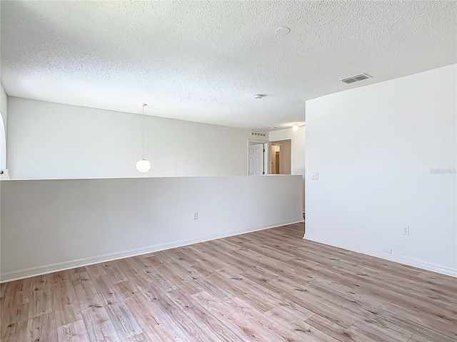 2384 Andrews Valley Dr, Kissimmee, FL 34758 - empty room with wood finished floors, a textured ceiling, and baseboards