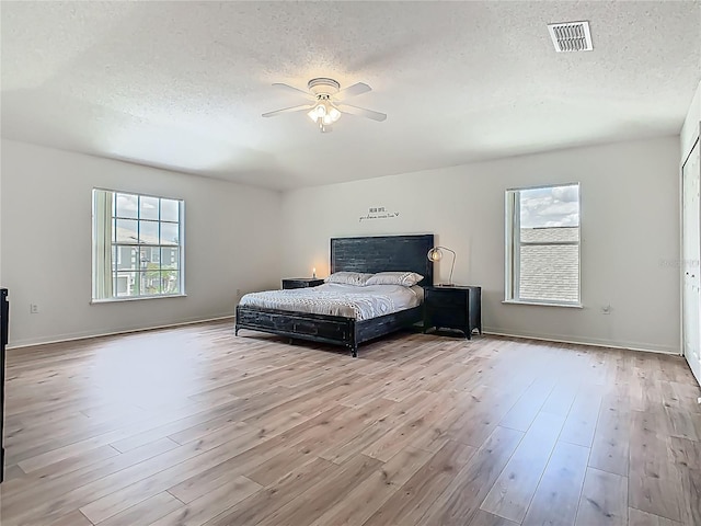 2384 Andrews Valley Dr, Kissimmee, FL 34758 - bedroom featuring a textured ceiling, wood finished floors, ceiling fan, and baseboards