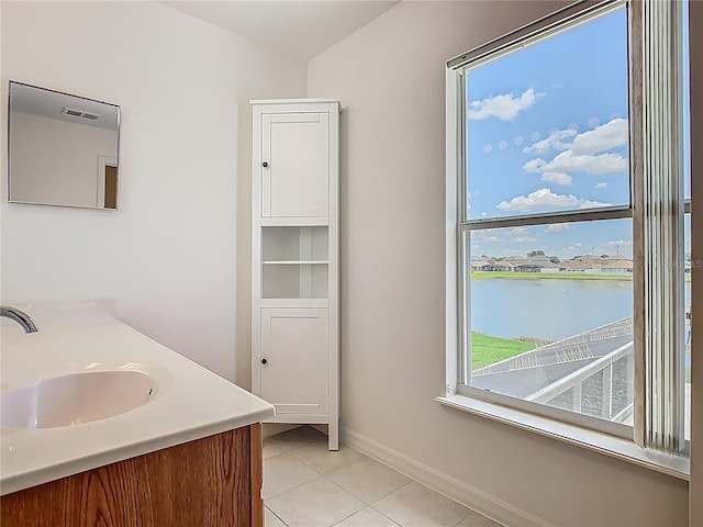 2384 Andrews Valley Dr, Kissimmee, FL 34758 - bathroom featuring tile patterned flooring, baseboards, vanity, and a water view