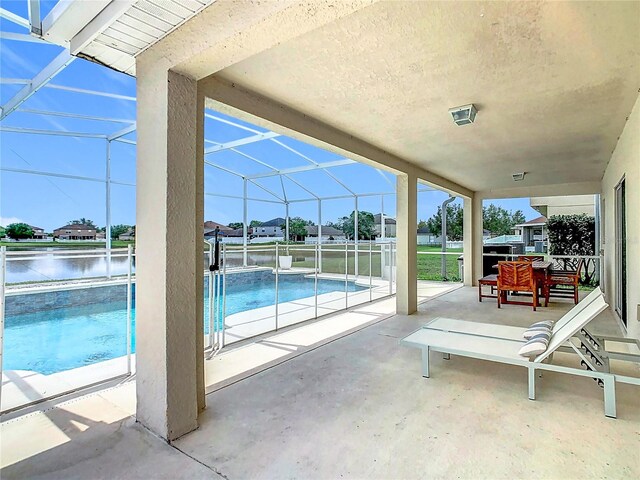 2384 Andrews Valley Dr, Kissimmee, FL 34758 - view of patio / terrace featuring an outdoor pool, a lanai, and a water view
