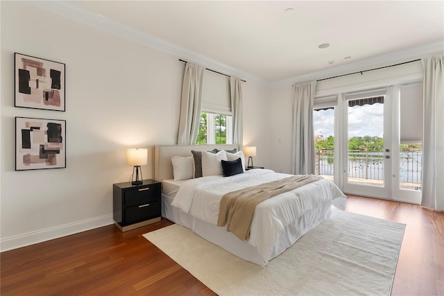 1010 Terrace Blvd, Orlando, FL 32803 - bedroom with access to outside, crown molding, wood finished floors, a water view, and baseboards