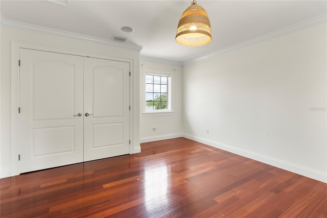 1010 Terrace Blvd, Orlando, FL 32803 - unfurnished bedroom featuring wood finished floors, baseboards, crown molding, and a closet