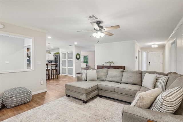 921 Torchwood Dr, Deland, FL 32724 - living room featuring wood finished floors, ornamental molding, a ceiling fan, recessed lighting, and baseboards
