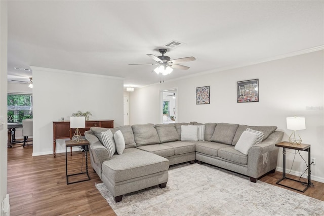921 Torchwood Dr, Deland, FL 32724 - living area featuring a ceiling fan, wood finished floors, ornamental molding, and baseboards