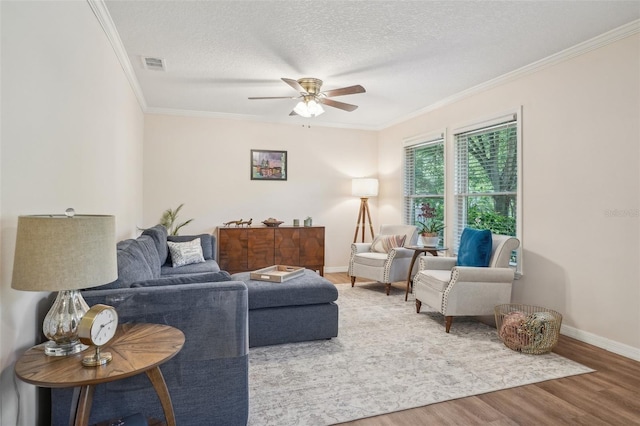 921 Torchwood Dr, Deland, FL 32724 - living room with wood finished floors, a ceiling fan, crown molding, baseboards, and a textured ceiling
