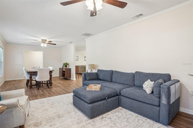 921 Torchwood Dr, Deland, FL 32724 - living area featuring ceiling fan, ornamental molding, wood finished floors, and baseboards
