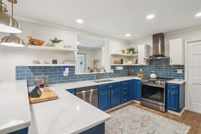 921 Torchwood Dr, Deland, FL 32724 - kitchen with stainless steel appliances, wall chimney range hood, open shelves, a sink, and blue cabinetry
