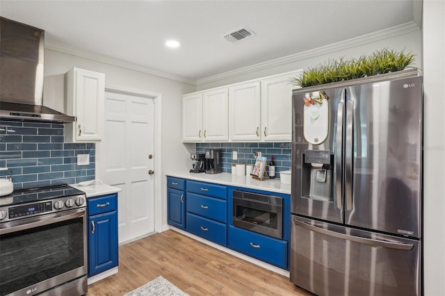921 Torchwood Dr, Deland, FL 32724 - kitchen with stainless steel appliances, wall chimney range hood, blue cabinetry, white cabinets, and ornamental molding