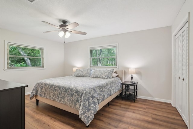 921 Torchwood Dr, Deland, FL 32724 - bedroom featuring wood finished floors, multiple windows, a closet, and baseboards